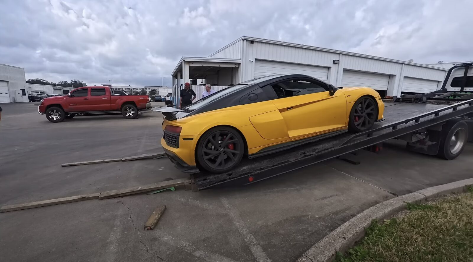 Professional flatbed towing service showing proper vehicle loading technique